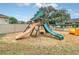 Community playground area with slides, swings, and other fun equipment is adjacent to a community swimming pool at 1401 Yellow Finch Dr, Davenport, FL 33837