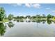 Beautiful still pond reflecting blue skies has a fountain and tree-lined shores for a peaceful setting at 1401 Yellow Finch Dr, Davenport, FL 33837