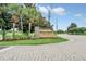 Attractive sign welcomes you to White Heron Golf Club, with palm trees and lush landscaping in the background at 1401 Yellow Finch Dr, Davenport, FL 33837