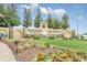 Ridgewood Lakes Del Webb community sign with water feature and colorful flower beds at 1401 Yellow Finch Dr, Davenport, FL 33837