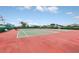 Outdoor tennis courts with vibrant red surface provide an excellent opportunity for recreation and exercise at 1401 Yellow Finch Dr, Davenport, FL 33837