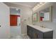 Bathroom featuring double sinks with modern vanity and decorative mirrors at 1455 Blue Horizon Dr, Clermont, FL 34714