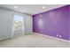 Bedroom with plush carpeting, a large window, and a bold accent wall at 1455 Blue Horizon Dr, Clermont, FL 34714