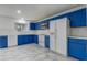 Bright kitchen features blue cabinets, white appliances, and tile flooring at 1455 Blue Horizon Dr, Clermont, FL 34714