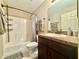 A bathroom that features a shower/tub combination and a vanity at 14598 Se 28Th Ct, Summerfield, FL 34491