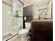 The bathroom features a walk-in shower, a toilet, and a sink with a wooden cabinet at 14598 Se 28Th Ct, Summerfield, FL 34491