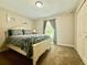 A well-lit bedroom with carpet, a window, closet doors, and soothing wall decor at 14598 Se 28Th Ct, Summerfield, FL 34491