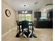 Stylish dining area featuring tile floors, a pendant light, and a geometric rug at 14598 Se 28Th Ct, Summerfield, FL 34491