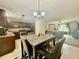 Open-concept dining area with a table and chairs connecting to the living room at 14598 Se 28Th Ct, Summerfield, FL 34491