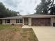 Inviting single-story house boasting a tidy front yard and an attached two-car garage at 14598 Se 28Th Ct, Summerfield, FL 34491