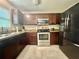 Well-equipped kitchen featuring tile floors and stainless steel appliances at 14598 Se 28Th Ct, Summerfield, FL 34491