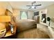 Comfortable primary bedroom with an en-suite bathroom and carpet floors at 14598 Se 28Th Ct, Summerfield, FL 34491