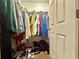 A walk-in closet filled with clothes, shoes, and other personal items at 14598 Se 28Th Ct, Summerfield, FL 34491