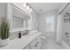 Bright bathroom featuring a shower-tub combo, ample vanity space, and a large mirror at 14848 Bonnybridge Dr, Orlando, FL 32826