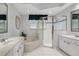 Bright bathroom with double vanity, jacuzzi tub, and glass-enclosed shower at 14848 Bonnybridge Dr, Orlando, FL 32826