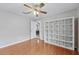 Bedroom with wood floors and large open shelving at 14848 Bonnybridge Dr, Orlando, FL 32826