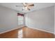 Bright bedroom with wood floors and a window dressed with a valance at 14848 Bonnybridge Dr, Orlando, FL 32826