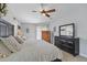 Bedroom with large bed, dresser, and neutral decor at 14848 Bonnybridge Dr, Orlando, FL 32826