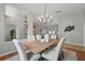 Bright dining room featuring modern chandelier and open floor plan to living room at 14848 Bonnybridge Dr, Orlando, FL 32826