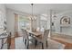 Elegant dining room showcasing a chandelier, a large window, and seating for six at 14848 Bonnybridge Dr, Orlando, FL 32826