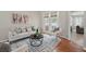 Bright living room featuring modern decor, neutral furniture, area rug, and french doors at 14848 Bonnybridge Dr, Orlando, FL 32826