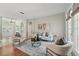 Bright living room featuring modern decor, neutral furniture, area rug, and french doors at 14848 Bonnybridge Dr, Orlando, FL 32826