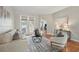 Bright living room with modern decor, neutral furniture, french doors and view to backyard at 14848 Bonnybridge Dr, Orlando, FL 32826