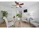 Home office with glass desk, neutral chairs and stylish decor at 14848 Bonnybridge Dr, Orlando, FL 32826