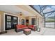 Relaxing covered patio features comfortable seating, ceiling fan, and convenient access to the pool area at 14848 Bonnybridge Dr, Orlando, FL 32826