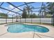 Sparkling private pool enclosed within a screened lanai, and surrounded by lush landscaping at 14848 Bonnybridge Dr, Orlando, FL 32826