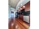 Modern kitchen features stainless steel appliances, wood cabinets, and hardwood flooring at 155 S Court Ave # 2403, Orlando, FL 32801