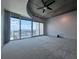 Bright living space with plush gray carpeting, ceiling fan, and expansive views at 155 S Court Ave # 2403, Orlando, FL 32801
