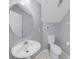 Compact bathroom featuring a pedestal sink, toilet, and tiled floors at 1802 Imperial Palm Dr, Apopka, FL 32712