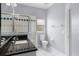 Clean bathroom features a granite countertop vanity and a tiled shower at 1802 Imperial Palm Dr, Apopka, FL 32712