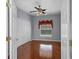 A cozy bedroom with hardwood floors, closet, and a window with a view at 1802 Imperial Palm Dr, Apopka, FL 32712