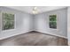 Sunlit bedroom features beautiful laminate floors, neutral walls, and large windows at 1802 Imperial Palm Dr, Apopka, FL 32712