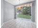 Bright dining area featuring tile floors, chandelier, and sliding door access to backyard at 1802 Imperial Palm Dr, Apopka, FL 32712