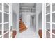 Bright foyer featuring wood and tile flooring and a staircase leading to the upper level at 1802 Imperial Palm Dr, Apopka, FL 32712