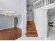 Inviting home foyer showcasing staircase, hardwood floors, and elegant light fixture at 1802 Imperial Palm Dr, Apopka, FL 32712