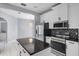 Modern kitchen featuring stainless steel appliances, center island, and bright white cabinets at 1802 Imperial Palm Dr, Apopka, FL 32712