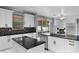 Modern kitchen with island, stainless appliances, and black countertops with white cabinets at 1802 Imperial Palm Dr, Apopka, FL 32712