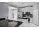 Well-lit kitchen featuring white cabinets, stainless steel appliances, and a stylish backsplash at 1802 Imperial Palm Dr, Apopka, FL 32712