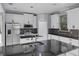 Modern kitchen featuring stainless steel appliances, center island, and custom cabinetry at 1802 Imperial Palm Dr, Apopka, FL 32712