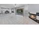 Bright living room with tile floors, fireplace, and an open flow to the kitchen at 1802 Imperial Palm Dr, Apopka, FL 32712