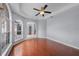 Bright living room with wood floors, a ceiling fan, and large windows at 1802 Imperial Palm Dr, Apopka, FL 32712