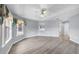 Spacious primary bedroom with wood floors, a ceiling fan, and ample natural light at 1802 Imperial Palm Dr, Apopka, FL 32712