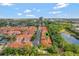 Aerial view of a beautiful community with lush greenery, a pond, and well-maintained townhomes at 1942 Michael Tiago Cir, Maitland, FL 32751
