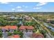 Aerial view of townhomes with tile roofs near a serene pond and lush landscaping at 1942 Michael Tiago Cir, Maitland, FL 32751