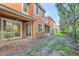 Exterior view of a two-story home with a patio and a well-maintained backyard at 1942 Michael Tiago Cir, Maitland, FL 32751