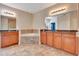 Bathroom featuring double sinks with granite countertops, cherry cabinets, bathtub, and tile floors at 1942 Michael Tiago Cir, Maitland, FL 32751